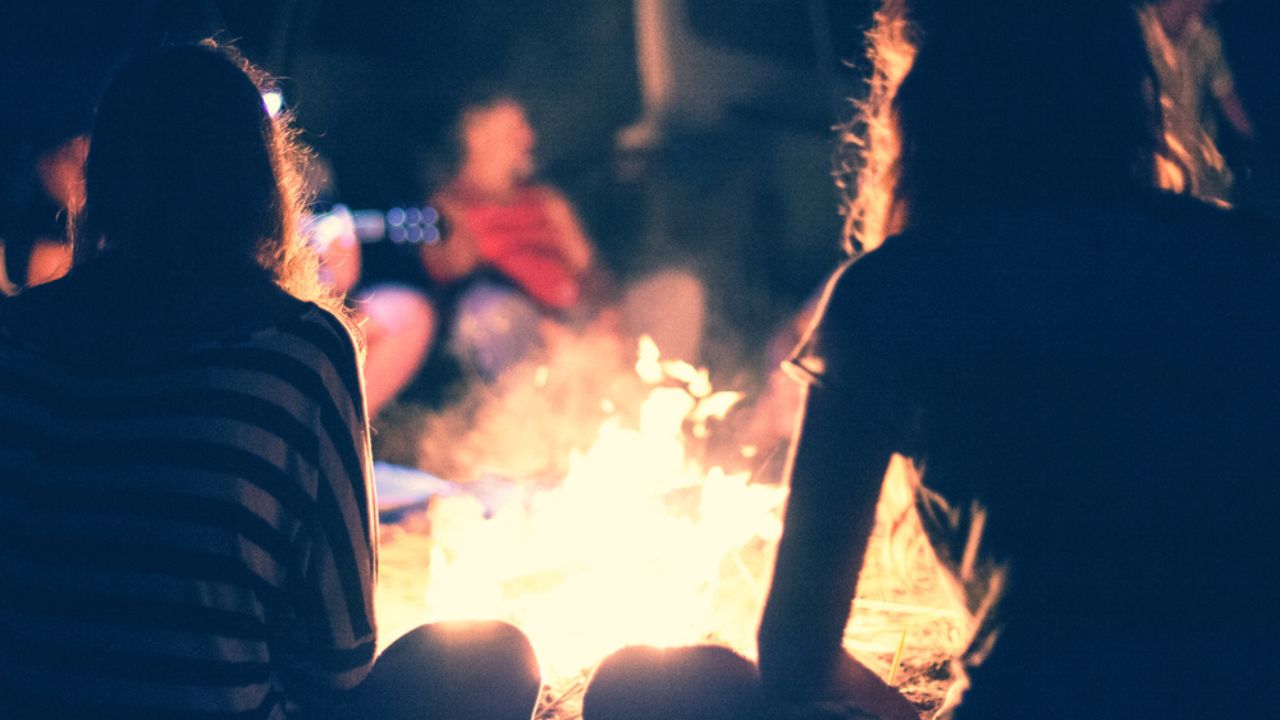 Play games around a campfire