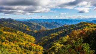 A breathtaking view of the Great Smoky Mountains in the Fall, with layers of mountain ridges in the distance.